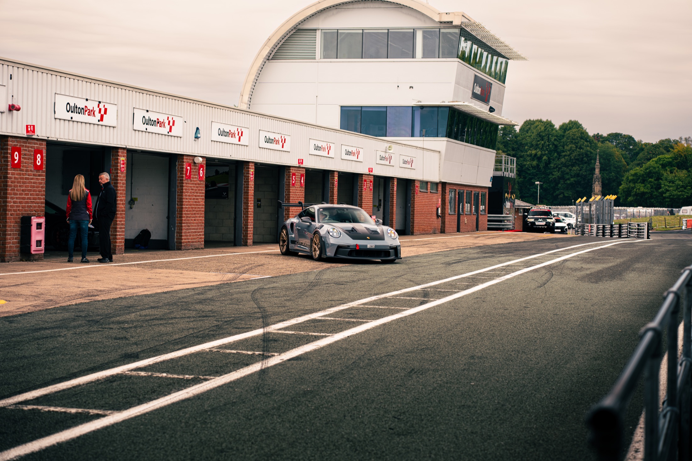 Porsche waiting beside the garages at Oulton Park
