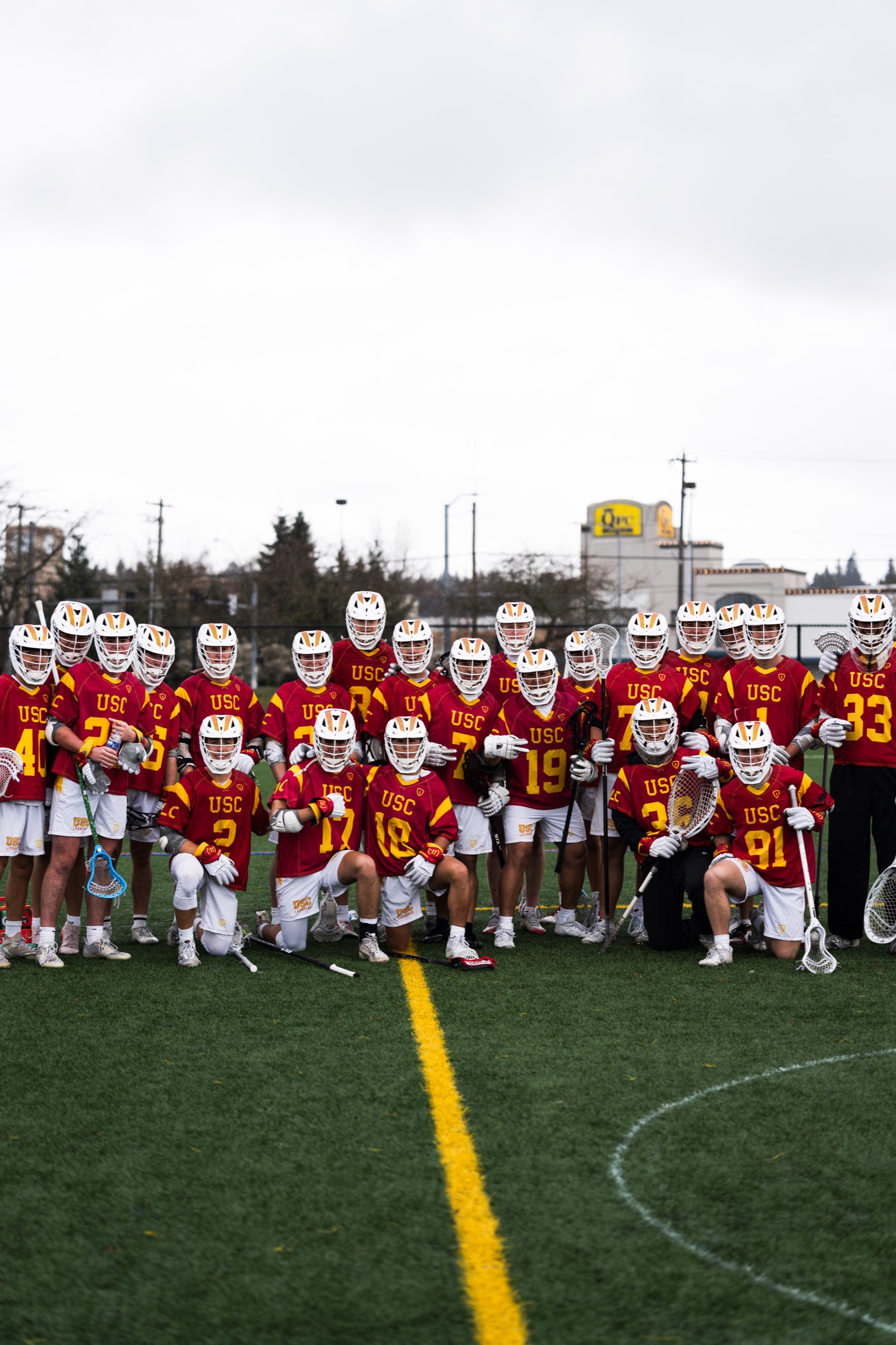 USC lacrosse team posed together on the field