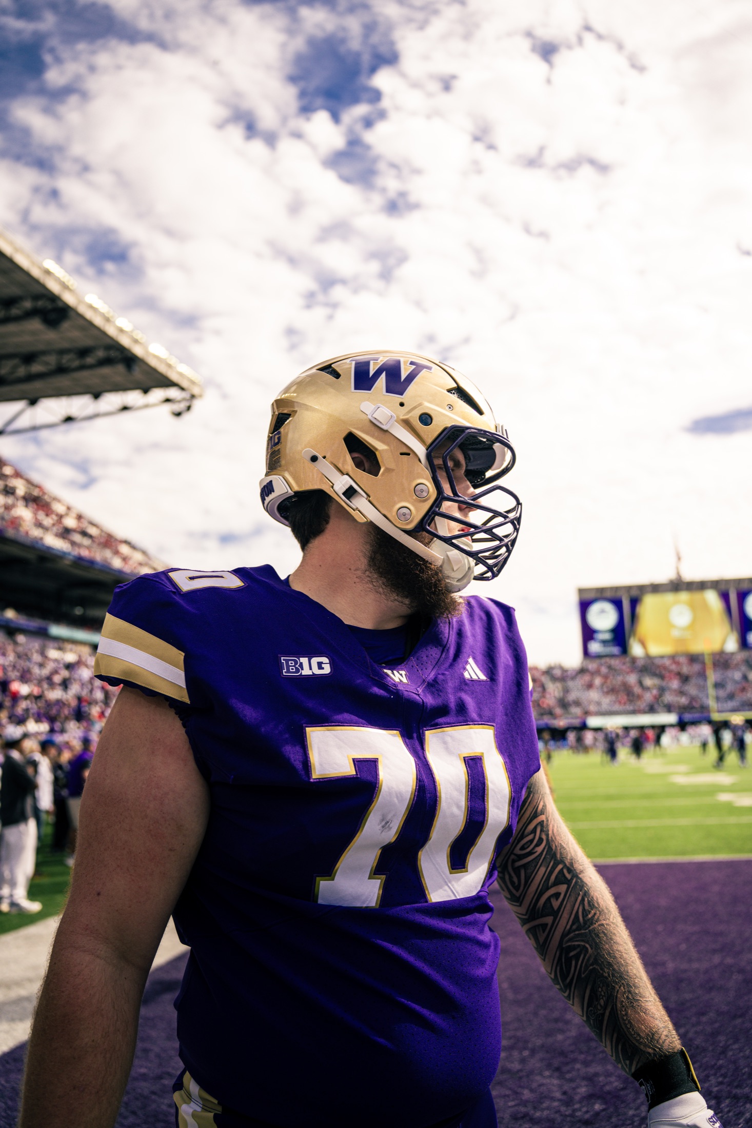 Washington lineman number seventy at field level beneath a bright sky