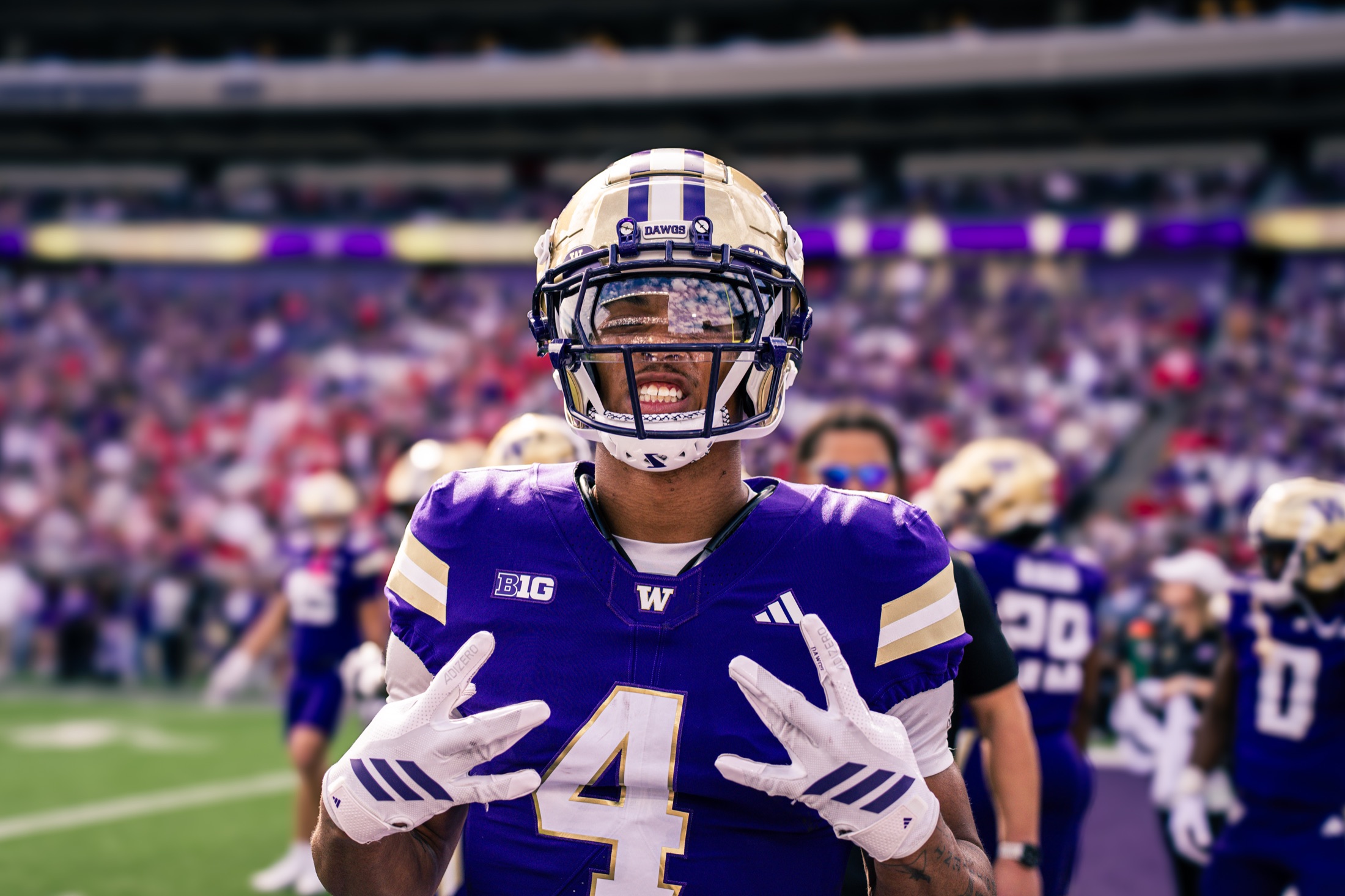 Washington player number four smiling toward the camera on the field