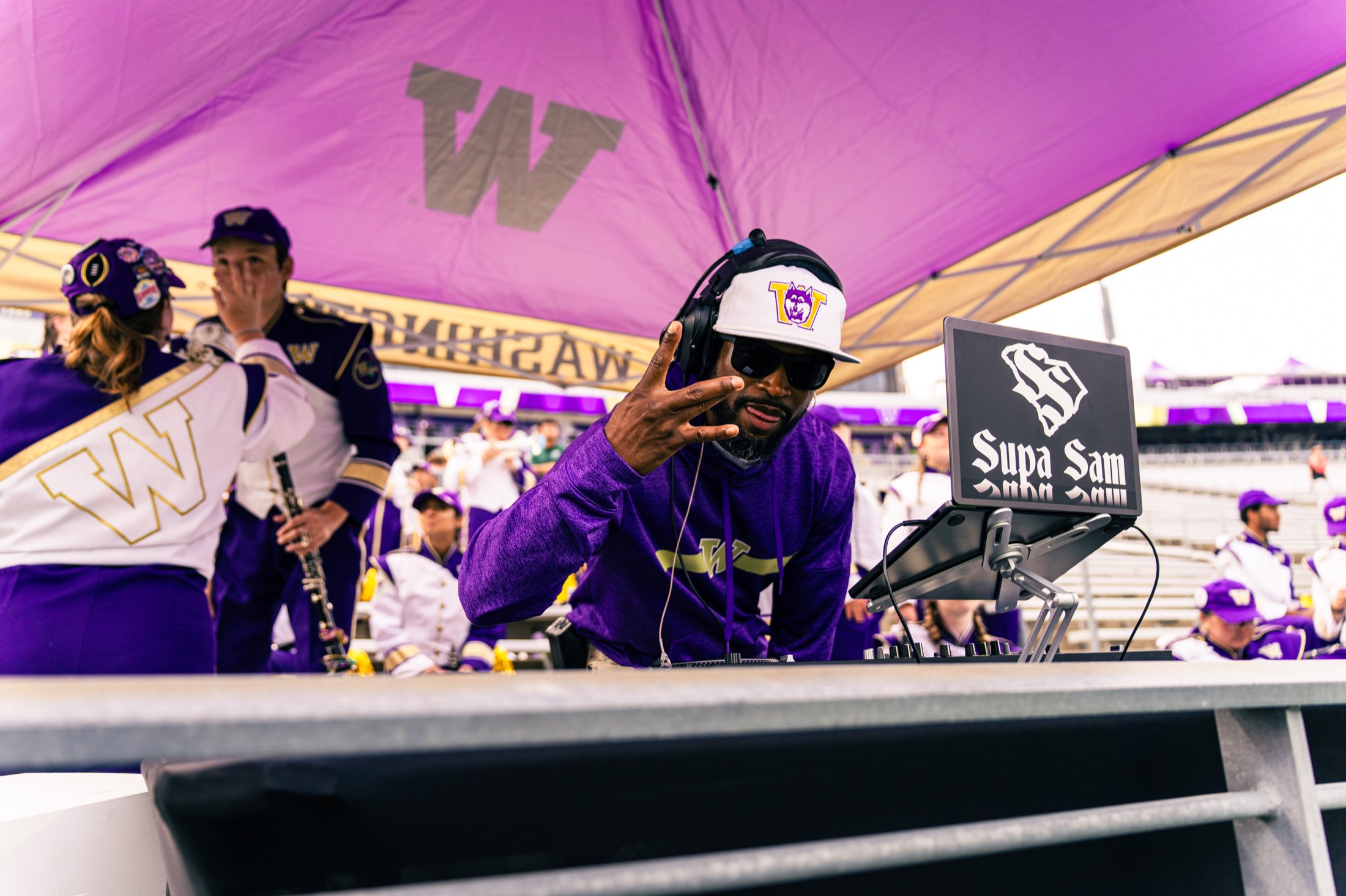 Washington stadium DJ Supa Sam at his booth in purple