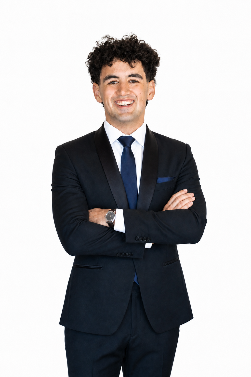 Wyatt Kaufman smiling with his arms crossed in a dark suit